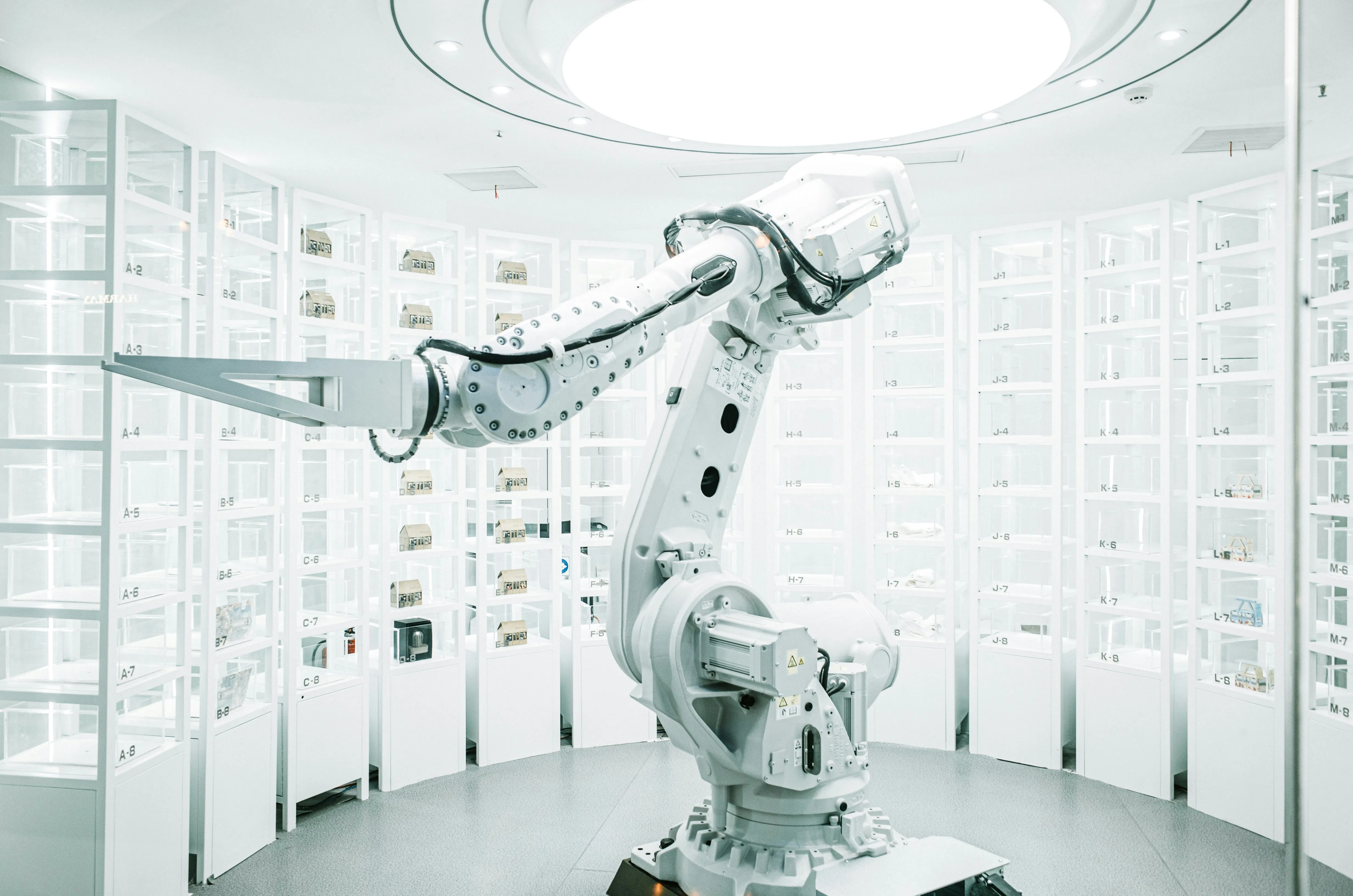 Industrial robotic arm in a white automated storage facility